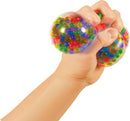 A hand squeezing a colorful, squishy Nee Doh Squeezy Peezy toy filled with vibrant gel beads, designed to provide sensory stimulation and stress relief.