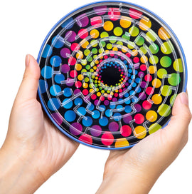 A person holding the colorful Tin BB Maze by Schylling, featuring a vibrant spiral design with large polka dots and a clear plastic maze structure on top. The maze is challenging and engaging, making it a fun toy for kids and adults alike.