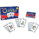 Quiddler card game by Set Games featuring a box and cards spread out. The box is colorful with the words 'Quiddler' and 'Short Word Game' prominently displayed. Cards showing letters and words scatter in front, inviting players to form words.