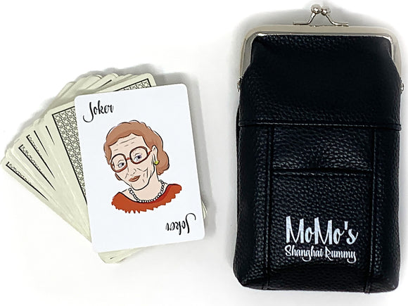 Momo's Shanghai Rummy card game by Solid Roots featuring a pack of cards, including a Joker card with a playful illustration, alongside a sleek black carrying case.