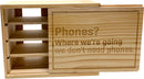 The Device Detox Box from Solid Roots is a beautifully crafted wooden storage box that promotes digital detox. It features a playful engraving that reads, 'Phones? Where we're going we don’t need phones.' The box includes multiple compartments for organizing devices or other personal items, encouraging a break from screens with its stylish yet functional design.