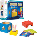 The Bunny Peek A Boo mechanical puzzle by SmartGames features a colorful box with a rabbit partially hidden inside. It includes a blue cube with a star and circle cutout, a yellow base, a red block, and several challenge cards. The game promotes problem-solving and sensory skills in preschoolers, providing various challenges to find the bunny's location.