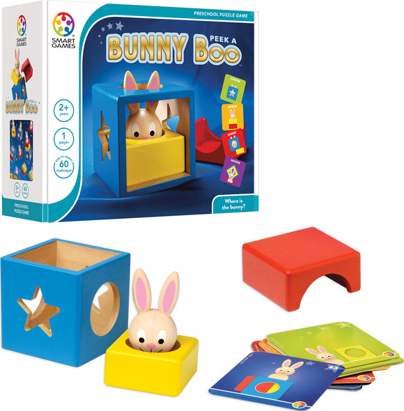 The Bunny Peek A Boo mechanical puzzle by SmartGames features a colorful box with a rabbit partially hidden inside. It includes a blue cube with a star and circle cutout, a yellow base, a red block, and several challenge cards. The game promotes problem-solving and sensory skills in preschoolers, providing various challenges to find the bunny's location.