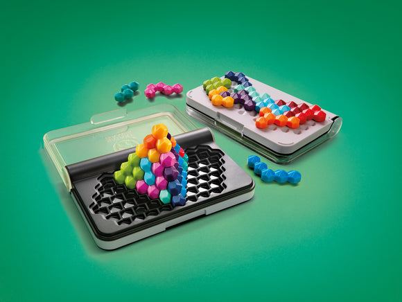 The IQ Six Pro by Smart Toys & Games features a variety of colorful hexagonal pieces arranged in creative configurations on two black and white puzzle boards. One board showcases a 3D structure made of vibrant colors, while the other displays a linear arrangement of pieces. The playful design and diverse colors make it visually appealing for puzzle enthusiasts of all ages.
