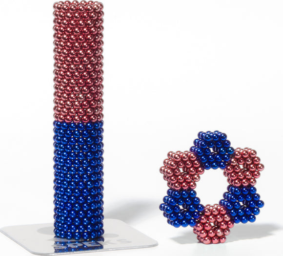 Speks Stripes Jellyfish by SPEKS, featuring colorful 3D magnetic designs made of red and blue spheres. The image showcases a tall stack and a complex shape, perfect for creative building and stress relief.