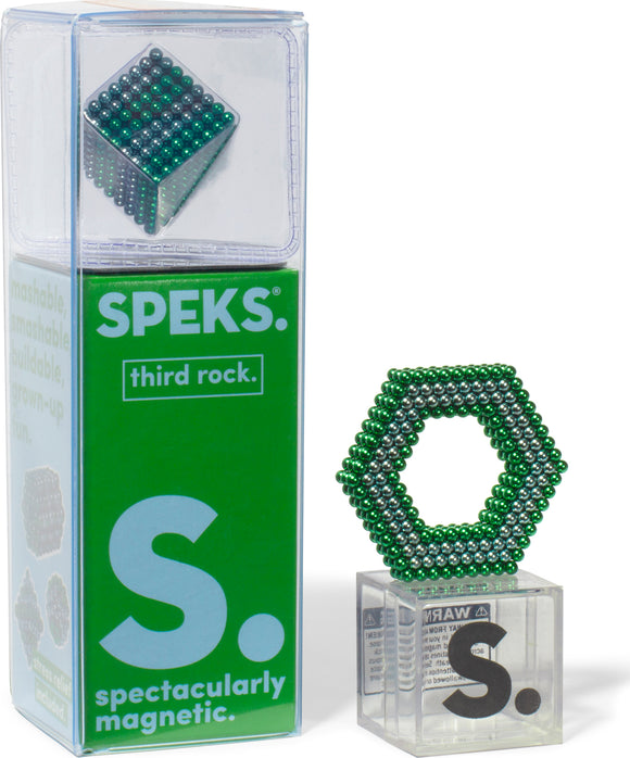 The Speks Stripes Third Rock, a magnetic building set by SPEKS, featuring vibrant green and silver beads. The product is displayed in a clear box, showcasing a hexagonal structure made from the beads, highlighting its creative and stress-relieving capabilities. The packaging bears the brand's logo and the phrase 'spectacularly magnetic.'
