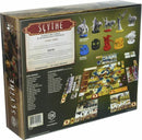 The back of the Scythe board game box by Stonemaier Games. It features detailed illustrations, game components, and descriptions, showcasing the artistic design, character miniatures, and the game board layout for strategic gameplay. The box highlights its designed by Jamey Stegmaier and includes backstory, global components, and faction-specific elements, ideal for 1-7 players with a playtime of 90-115 minutes.