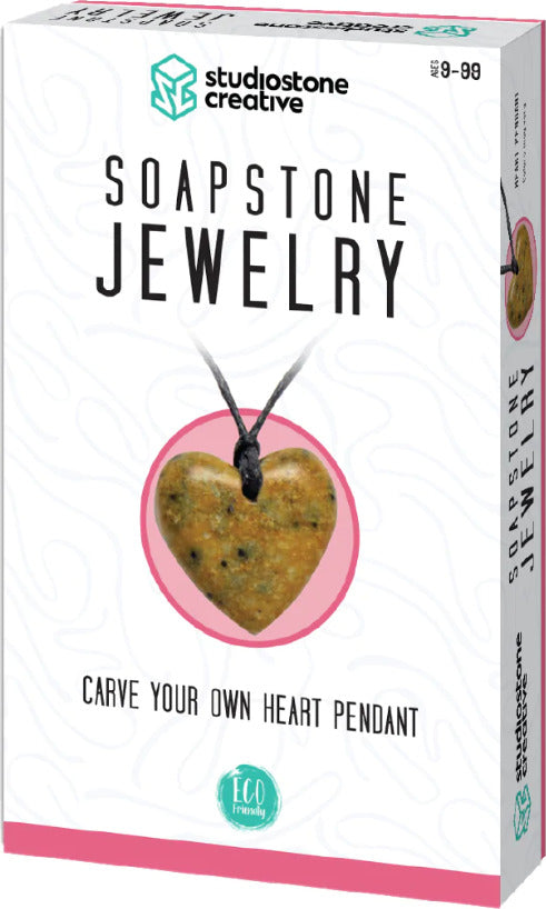 A DIY jewelry kit from Studiostone Creative featuring a soapstone heart pendant. The kit encourages users to carve their own pendant, promoting creativity and craftsmanship. The package design is colorful and showcases the heart pendant on a black cord, emphasizing an eco-friendly approach.