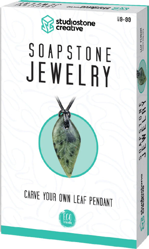A DIY jewelry kit titled 'Soapstone Jewelry' by Studiostone Creative, featuring a vibrant leaf pendant design. The kit provides materials and instructions to carve your own unique leaf pendant, emphasizing eco-friendliness. The packaging is colorful and engaging, showcasing the pendant prominently.