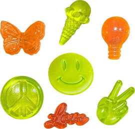 A colorful assortment of gel-like candies in various shapes including a butterfly, ice cream cone, light bulb, peace symbol, smiley face, and the word 'Love'. Each candy is vibrantly colored in shades of orange and green, displaying a fun and playful design, perfect for creative activities.
