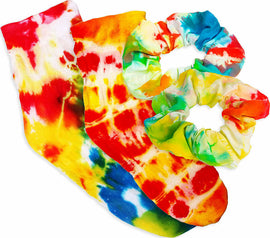 A colorful set of tie-dye accessories including two vibrant socks in red, orange, yellow, and blue hues, and a matching scrunchie with a similar multicolored pattern. This DIY kit showcases creativity and fun, perfect for personalizing your wardrobe.