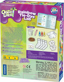 The Rainbow Tie-Dye Lab by Thames & Kosmos is a DIY science kit designed for kids. The colorful packaging displays tie-dye tools, including gloves, bottles of non-toxic dyes (red, yellow, blue), a beaker, a pair of socks, scrunchies, and a detailed instruction manual. It encourages creativity and experimentation with fabric dyeing, perfect for young science enthusiasts.
