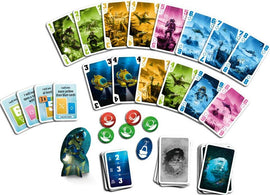 The Crew: Mission Deep Sea game by Thames & Kosmos featuring a collection of colorful cards, objective cards, tokens in various colors, and a submarine figure. The cards depict underwater scenes and characters, offering an engaging cooperative gaming experience for players.