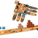 Imhotep: The Duel game set by Thames & Kosmos featuring a colorful board shaped like a hand. Players build pyramids and manage resources using tokens and game pieces displayed around the board. In the foreground, there are scoring markers and various shaped blocks representing building elements. The imagery suggests a competitive and strategic two-player game.