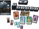 The Grand Hotel Abaddon game set by Thames & Kosmos includes an adventure book and various game cards featuring characters and hints. The image shows the game's beautifully illustrated components spread out, with character cards, multiple stacked cards, and question tokens, all set against a backdrop of the grand hotel.