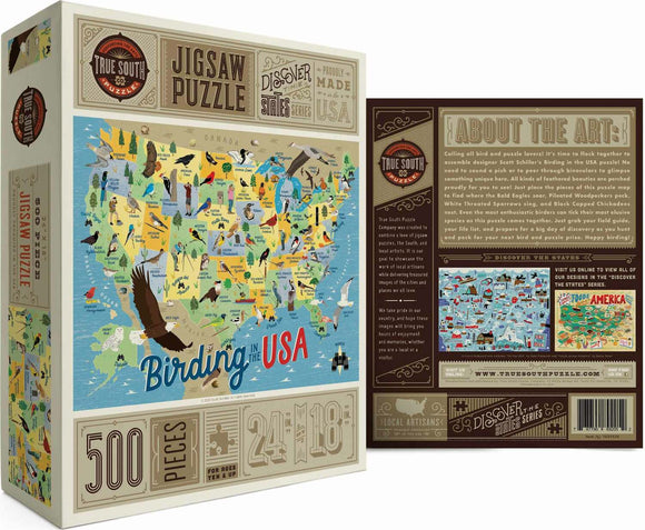 True South Puzzles Jigsaw Puzzle titled 'Birding in the USA'. The puzzle features a colorful map of the USA with various bird species highlighted in different states. The box indicates it has 500 pieces and measures 24 x 18 inches when assembled. The artwork is designed by Scott Schiller and invites bird enthusiasts to discover different bird species across the country.
