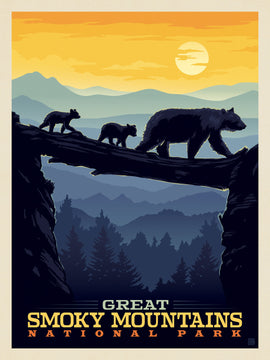 A colorful jigsaw puzzle featuring an artistic depiction of bears walking along a log in the Great Smoky Mountains National Park during sunset. The scene includes a mother bear and two cubs, with lush mountain ranges and a bright orange sun in the background, evoking a serene wilderness atmosphere.