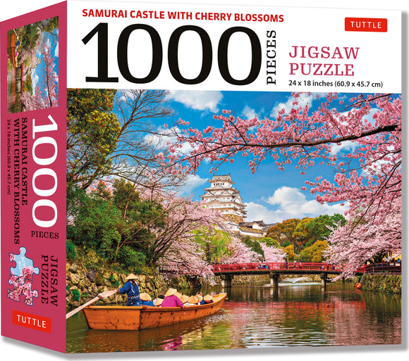 A beautifully designed jigsaw puzzle featuring the Samurai Castle surrounded by cherry blossoms. The puzzle has 1000 pieces and measures 24 x 18 inches. The vibrant artwork showcases a serene scene with a tranquil river, a wooden boat with people in traditional attire, and a backdrop of pink cherry blossom trees against a clear blue sky.