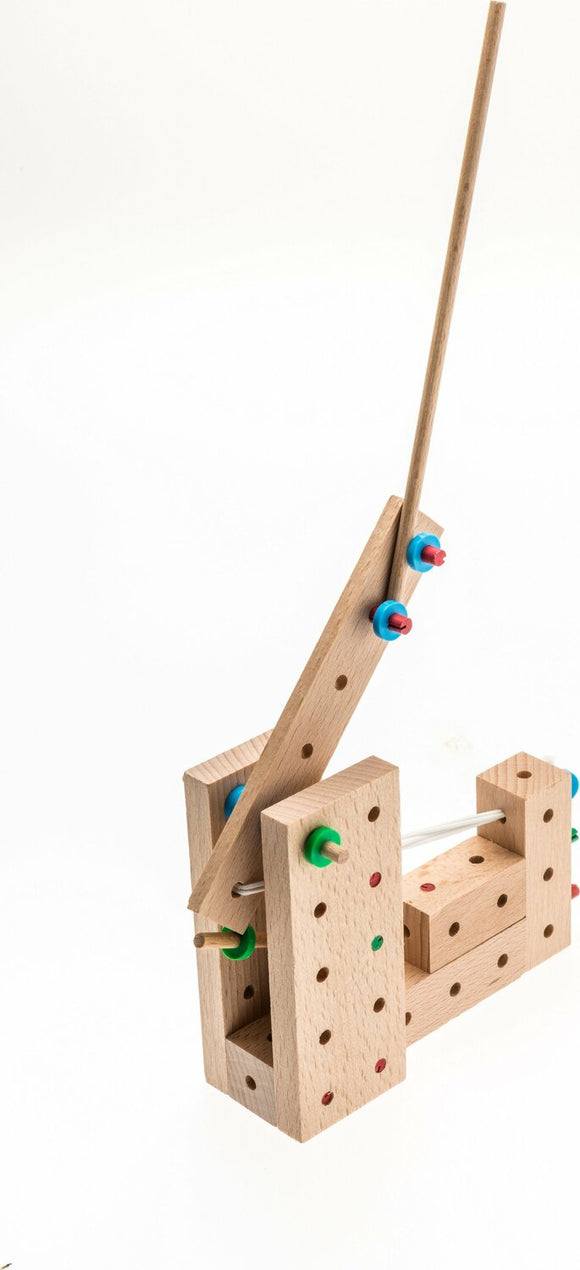 The Catapults Explorer DIY kit by Matador consists of 56 pieces to build a functional catapult. It features wooden blocks with holes, various colored connectors, and a launching arm, designed to engage children in creative construction and play.