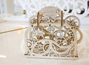 A beautifully crafted UGears 3D Theater wooden model kit showcasing intricate gears and designs. The structure features detailed engravings with the word 'UGears' and 'THEATER' on the top, perfect for DIY enthusiasts and mechanical puzzle lovers.