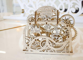 A beautifully crafted UGears 3D Theater wooden model kit showcasing intricate gears and designs. The structure features detailed engravings with the word 'UGears' and 'THEATER' on the top, perfect for DIY enthusiasts and mechanical puzzle lovers.