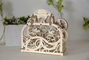 A beautifully crafted UGears 3D Theater DIY kit made of laser-cut wood. The intricate design features gears, patterns, and an ornate arch with the 'UGears Theater' engraving at the top. The model showcases an engaging mechanical aesthetic suitable for hobbyists and DIY enthusiasts.
