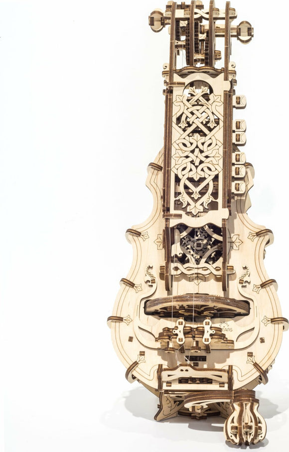 The UGears 3D Hurdy-Gurdy kit features intricately designed wooden components that come together to create a mechanical musical instrument. Detailed carvings and a unique structure highlight its craftsmanship, showcasing the gears and strings that make up this DIY kit. Ideal for enthusiasts of woodworking and music, each piece fits together seamlessly to form a stunning and functional model.