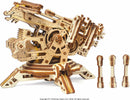 UGears 3D Archballista-Tower DIY kit displayed from the side. The intricate wooden model features gears, moving parts, and a towering design resembling a medieval ballista. Three additional wooden projectiles are placed beside the model, showcasing the craftsmanship and mechanical features.