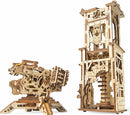UGears 3D Archballista-Tower DIY kit featuring a detailed, mechanically intricate tower and an archballista. The wooden models exhibit precise craftsmanship with visible gears and mechanisms, perfect for enthusiasts of mechanical puzzles and creative assembly.