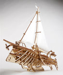 A detailed wooden 3D model of a Trimaran sailing ship by UGears 3D. The model features intricate designs with sails, a hull, and an artistic finish. Perfect for DIY enthusiasts, it showcases the craftsmanship and engineering involved in the assembly of this mechanical puzzle.