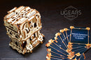 The UGears 3D Deck Box, a beautifully crafted mechanical puzzle kit made from wood. The intricate design features gears and cutouts, showcasing its unique aesthetic. Next to the box, there is a fanned-out set of game cards, adding to the appeal of this DIY kit perfect for enthusiasts who enjoy building and playing.