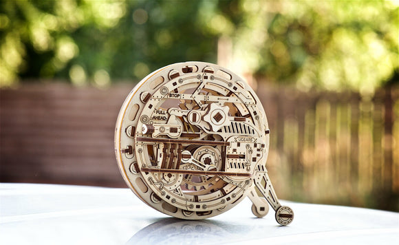 A beautifully crafted UGears 3D Monowheel DIY kit features intricate wooden gears and mechanisms. It showcases a unique design with engraved instructions such as 'FULL AHEAD' and 'STOP'. Perfect for mechanical puzzle enthusiasts and creative individuals looking for an engaging build.