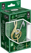 The Hanayama Cast Harmony Mechanical Puzzle features an intricate design resembling musical notes, with a combination of gold and silver interlocking pieces. The box showcases a vibrant green background with bamboo imagery, emphasizing the puzzle's theme of harmony and connection. It includes a difficulty level of 2, inviting players to challenge themselves in taking it apart and reassembling it.