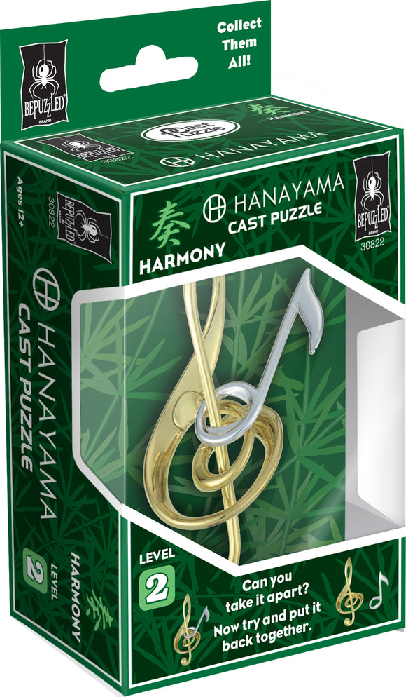 The Hanayama Cast Harmony Mechanical Puzzle features an intricate design resembling musical notes, with a combination of gold and silver interlocking pieces. The box showcases a vibrant green background with bamboo imagery, emphasizing the puzzle's theme of harmony and connection. It includes a difficulty level of 2, inviting players to challenge themselves in taking it apart and reassembling it.