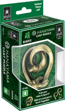 The Hanayama Cast Radix puzzle features a complex, intertwined design made of a shiny bronze-like material. It is packaged in a green box displaying its name and level 4 difficulty, with images of the puzzle at different angles. The box includes instructions that challenge users to take the puzzle apart and reassemble it.