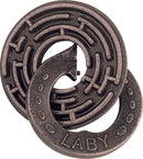 The Cast Labyrinth puzzle by Hanayama, featuring a circular design with a labyrinth pattern. It has a unique mechanical structure, made of durable metal, offering a captivating challenge for puzzle enthusiasts. The piece exhibits a fusion of art and engineering, highlighting intricate details.