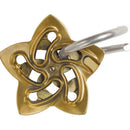 The Cast Helix mechanical puzzle by Hanayama features an intricate star-shaped design made of brass. The puzzle showcases a combination of circles and curved lines in a charming, polished finish, with a metal loop attached that adds to its complexity. Perfect for puzzle enthusiasts seeking a challenge.