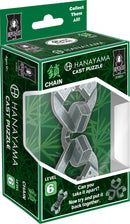 A box displaying the Hanayama Cast Chain mechanical puzzle. The packaging features a silver chain puzzle partially visible through a transparent window. The box is decorated with green bamboo graphics and includes the brand logo and a label indicating it's a level 6 puzzle, challenging users to take it apart and reassemble it.