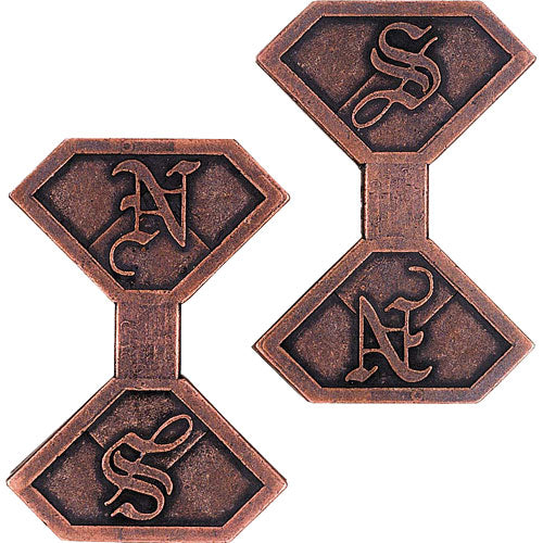 A close-up view of the Hanayama Cast News mechanical puzzle, featuring intricate, interlocking shapes made from antique-looking metal with detailed engravings of letters. The design showcases its unique and challenging construction, intended for puzzle enthusiasts.