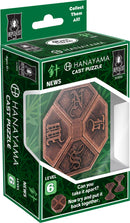 Hanayama Cast News mechanical puzzle featuring a hexagonal design with intricate engravings. The packaging showcases the puzzle's complexity with a level 6 difficulty rating, challenging users to disassemble and reassemble the pieces.
