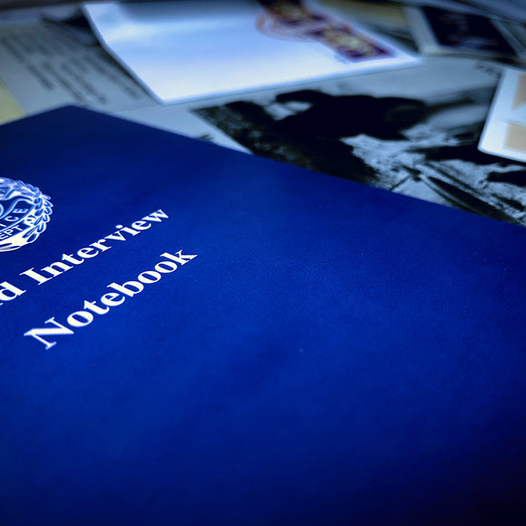 The Underwood Cellars - Winemaker game box is prominently displayed with its vibrant blue cover, featuring the title 'Underwood Cellars - Winemaker' in bold white text. Surrounding the box are various vintage photographs and documents that hint at the rich history of winemaking.