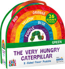 Colorful packaging of The Very Hungry Caterpillar Floor Puzzle by Briarpatch Inc. The puzzle features a rainbow design and has 26 giant pieces ideal for children ages 3 and up. It showcases vibrant colors and the beloved caterpillar character, promoting early learning and fun.
