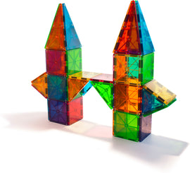A vibrant 100-piece set of Magna Tiles in clear colors, featuring a colorful castle-like structure with triangular and square shapes, designed for creative play and learning. The tiles are translucent and come in a variety of bright colors, including red, blue, green, and yellow, encouraging imaginative designs and spatial awareness.