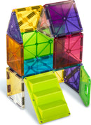 A colorful 28-piece Magna Tiles House set featuring transparent geometric shapes in vibrant colors such as yellow, purple, green, orange, and red. The structure includes windows, doors, and a staircase, showcasing the creativity and playfulness of this DIY building kit designed for children.