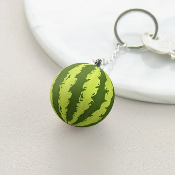 A vibrant watermelon puzzle keychain by Pintoo, featuring a colorful spherical design resembling a watermelon. The keychain is attached to a metal ring, ideal for holding keys or as a fun accessory. Perfect for puzzle enthusiasts and fans of quirky, playful items.