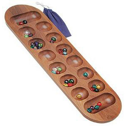 A large Mancala game made of wood, featuring a smooth wooden board with deep, rounded pits for player stones. Colorful game pieces are present, and a blue pouch is included for storage.