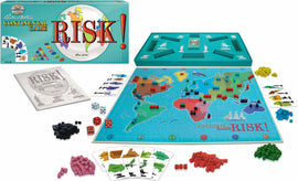 An image of the board game 'Risk!' by Winning Moves. The game includes a colorful map of the world with territories colored in various shades. Several red, green, blue, and black game pieces are scattered around the board, alongside dice and cards. The box of the game is shown, featuring the title 'Risk!' prominently. The layout suggests an engaging strategy game perfect for multiplayer fun.