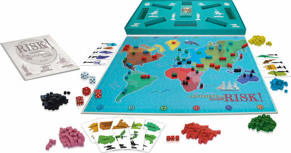 The game Risk by Winning Moves, featuring a colorful world map game board. Small plastic pieces in various colors represent armies, with dice and mission cards scattered around. The box includes strategic components for global domination gameplay.