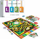 The Game of Life by Winning Moves, featuring a colorful board game layout with a winding path, houses, and play money. The box is brightly designed with the title 'The Game of Life' prominently displayed, indicating it's a family game suitable for ages 10 and up. Various components include player pieces, bills in different denominations, and a spinner for gameplay.